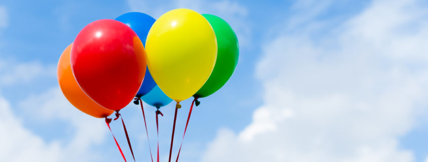 Multicolored balloons in blue sky